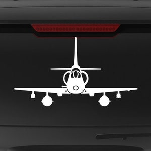 May include: A black SUV with a white silhouette of a jet plane on the back window. The vehicle has a "Veteran Owned Business" sticker on the back bumper.