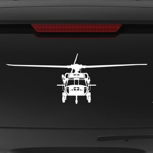 May include: A black SUV with a white silhouette of a helicopter on the back window. The vehicle has a "Veteran Owned Business" sticker on the back bumper.