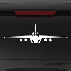 May include: A black SUV with a white silhouette of a military aircraft on the back window. The vehicle has a "Veteran Owned Business" sticker on the back bumper.