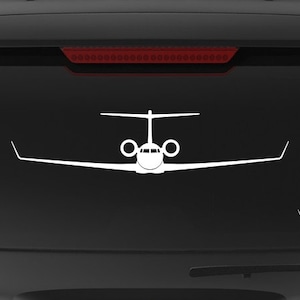 May include: A black SUV with a white silhouette of a private jet on the back window. The vehicle has a "Veteran Owned Business" sticker on the back bumper.