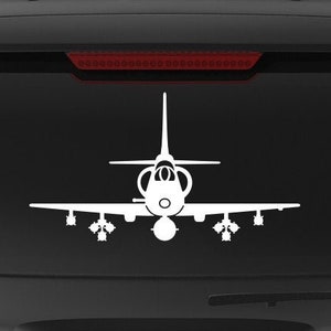 May include: A black SUV with a white silhouette of a fighter jet on the back window. The car has a "Veteran Owned Business" sticker on the back.