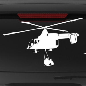 May include: A black SUV with a white silhouette of a helicopter on the back window. The helicopter is carrying a bucket. The SUV has a "Veteran Owned Business" sticker on the back.