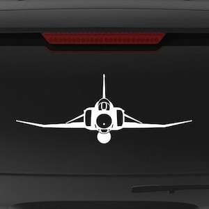 May include: A black SUV with a white silhouette of a fighter jet on the back window. The vehicle has a "Veteran Owned Business" sticker on the back bumper.