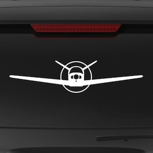 May include: A black SUV with a white silhouette of a small plane on the back window. The car has a "Veteran Owned Business" sticker on the back bumper.