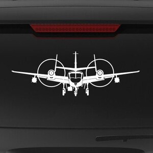 May include: A black SUV with a white silhouette of a plane on the back window. The car has a "Veteran Owned Business" sticker on the back bumper.