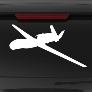 May include: White vinyl decal of two unmanned aerial vehicles (UAVs) on a black vehicle window. The decal includes the text "Veteran Owned Business" and the website "fegraphics.com".