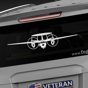 May include: A gray SUV with a white silhouette of a plane on the back window. The vehicle has a "Veteran Owned Business" sticker with an American flag on it. The text "www.fegraphics.com" is printed on the back of the vehicle.