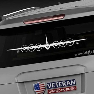May include: A white decal of a large airplane is affixed to the rear window of a silver SUV. The decal features the outline of the aircraft with multiple propellers. The website address www.fegraphics.com is printed on the window. A "Veteran Owned Business" sticker is also visible.