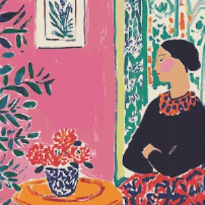 May include: A vibrant painting shows a woman in a black top and patterned skirt, seated near a table with a vase of red flowers. The background includes a pink wall, patterned curtains, and a framed botanical print.