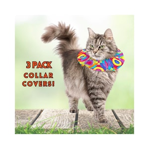 May include: A gray cat wearing a colorful, patterned, inflatable collar. The collar is shaped like a donut and has a variety of colors, including red, yellow, blue, green, and purple. The text "3 PACK COLLAR COVERS!" is in the upper left corner of the image.