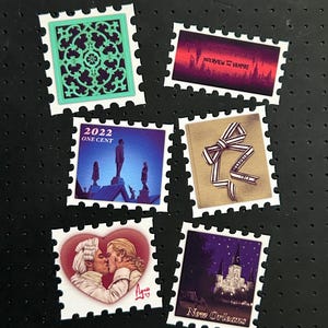 May include: Six rectangular postage stamp stickers featuring diverse designs: a teal wrought iron pattern, a red and black Interview with the Vampire graphic, a 2022 One Cent stamp with silhouettes, a striped ribbon, a couple kissing in a heart, and New Orleans.