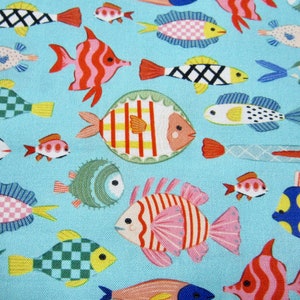 May include: A blue fabric with a repeating pattern of colorful fish. The fish are in various shapes and sizes, with some having stripes, polka dots, and checkered patterns.