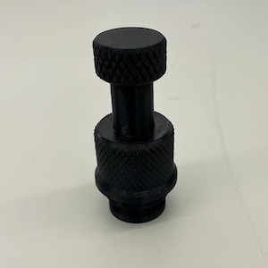 May include: A black plastic knob with a threaded base and a textured top.