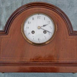 May include: A white ceramic mug with a black handle and the text "But First, Coffee" in a handwritten style. The mug is on a white surface. The mug is 4 inches tall.