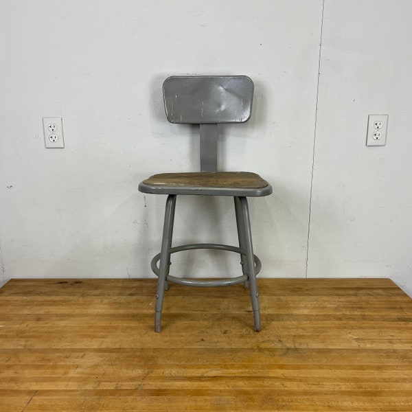 Light grey Vintage industrial 18-26” height adjustable Royal Industries stool with square masonite seat