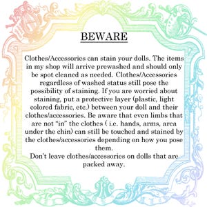 May include: A decorative frame with a pastel rainbow gradient border surrounds text that reads "BEWARE". The text warns about potential staining from doll clothes and accessories, advising protective measures.