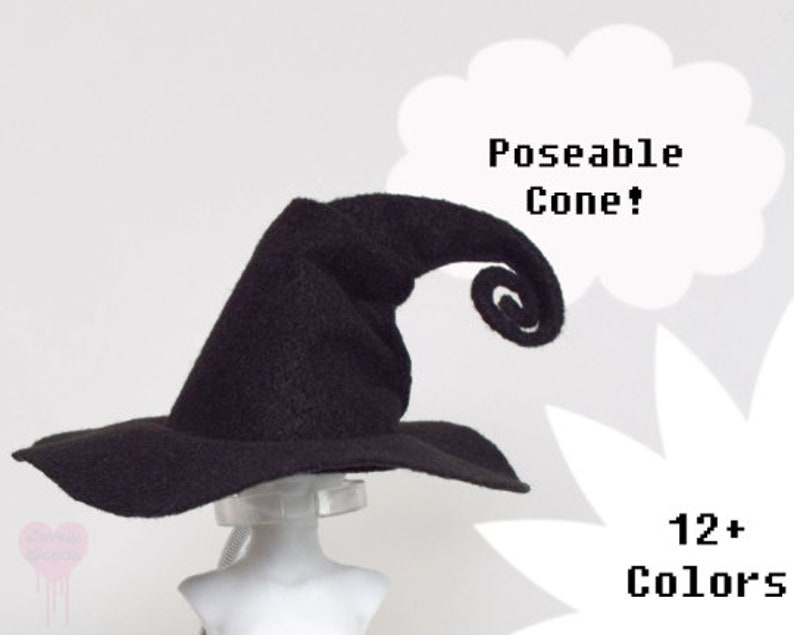 May include: A black witch hat with a wide brim and a curled, poseable tip. The text "Poseable Cone!" and "12+ Colors" are displayed in white. The hat is displayed on a mannequin head.