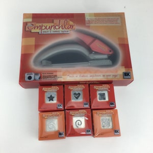 May include: A set of six Empunchlar punch and emboss system dies. The dies are red and white with a variety of designs including a star, heart, square, swirl, and a geometric pattern. The dies are packaged in individual boxes with the Empunchlar logo.
