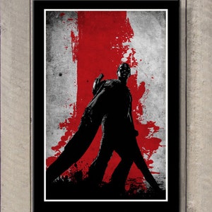 May include: Framed art print featuring a silhouetted figure against a backdrop of red and gray paint splatters. The artwork is encased in a black frame, creating a striking contrast. The image has a grunge aesthetic.
