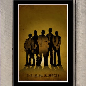 May include: A framed poster featuring a group of six silhouetted figures against a sepia-toned background. The text "THE USUAL SUSPECTS" is printed in a serif font at the bottom of the poster. The poster is encased in a black frame.