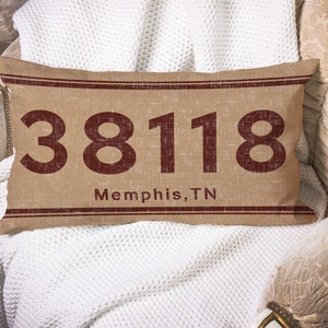 May include: A brown and beige rectangular cushion with the text "38118 Memphis, TN" in red.