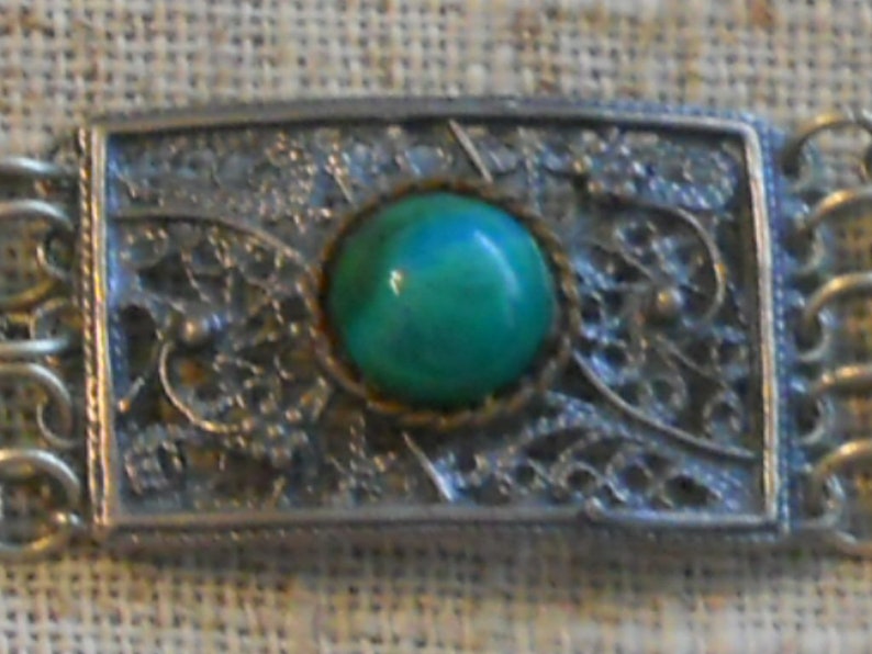 Vintage filigree bracelet with green stones