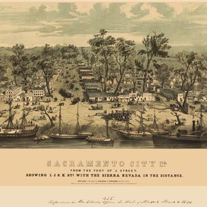 May include: An antique print of Sacramento City, showing J & K St! with the Sierra Nevada in the distance. The image depicts a detailed landscape with buildings, trees, ships, and people. The print has a sepia tone and includes text at the bottom.