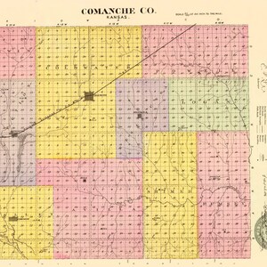 May include: A vintage map of Comanche County, Kansas, dated July 22, 1886. The map features a grid layout with sections colored in pink, yellow, and purple, displaying townships, rivers, and town names like Coldwater, Avilla, and Shimer.