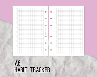 May include: A6 size habit tracker with a grid pattern and numbered columns. The paper is white and the grid lines are black.