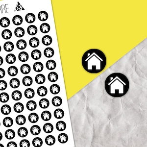 May include: A sheet of white paper with black and white house stickers. The stickers are in a circle shape with a white house icon inside. There are two individual stickers on a grey and yellow background.
