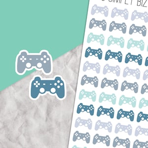 May include: A sheet of stickers featuring a variety of blue and grey video game controller designs. The controllers are in different shades of blue and grey, with some having a light blue or grey background.