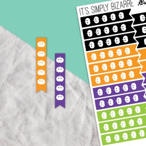 May include: A sheet of Halloween themed stickers with the text "It's Simply Bizarre" at the top. The stickers feature rows of white pumpkin faces on different colored backgrounds: black, orange, purple, and green.