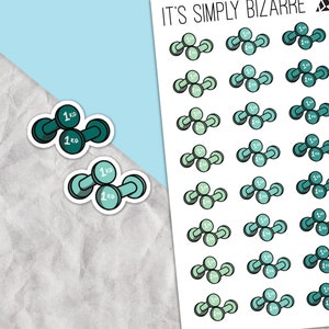 May include: A sheet of stickers featuring a repeated design of green and blue dumbbells with the text "1 ko" on each. The sheet is titled "It's Simply Bizarre".