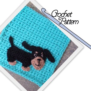 May include: Crochet pattern for a dachshund dog. The dog is black with brown accents and is sitting on a turquoise square.