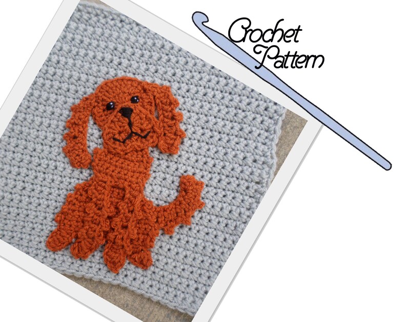 K&ouml;nnte beinhalten: H&auml;kelmuster f&uuml;r eine Hundefigur. Der Hund ist orange und hat schwarze Augen. Der Hintergrund ist ein graues H&auml;kelquadrat.