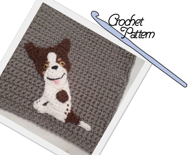 May include: Crochet pattern for a brown and white dog with brown ears and spots. The dog is sitting up with its tongue sticking out. The pattern is on a gray crocheted background. The text "Crochet Pattern" is written in blue on a white background.