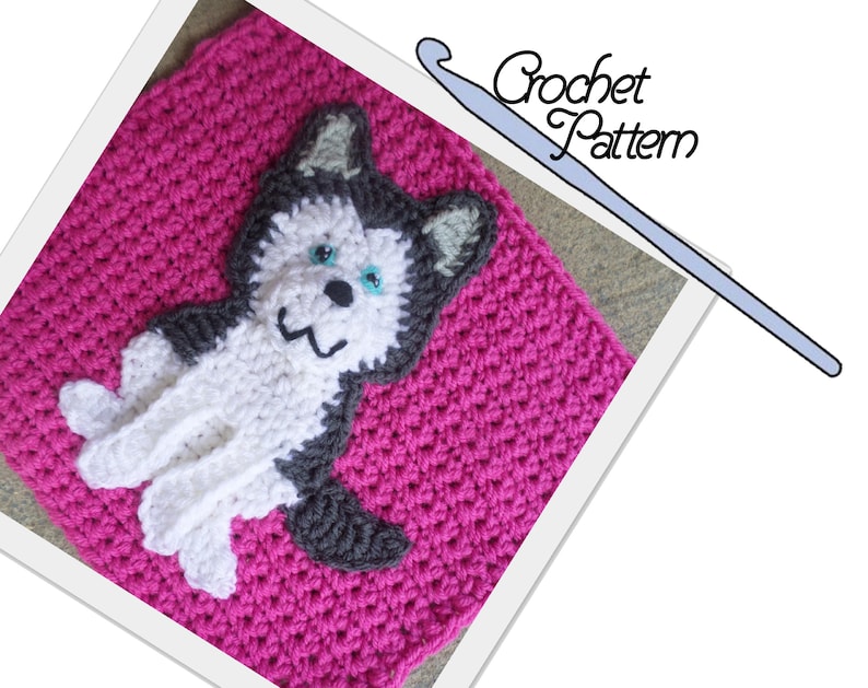 May include: A crochet pattern for a pink square with a gray and white husky applique. The pattern includes instructions for crocheting the square and the husky.
