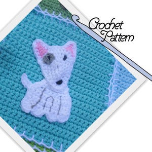 May include: A crochet pattern for a white dog with pink ears and a gray nose. The dog is sitting on a teal blue crocheted square. The text "Crochet Pattern" is written in black on a white background.