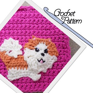 May include: A crochet pattern for a small dog, with a pink background and a white crochet hook. The dog is made with white, orange, and brown yarn.