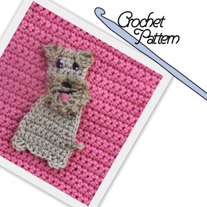 May include: A crocheted dog applique in brown and beige tones, with a pink tongue, on a pink crocheted background. The image includes the text "Crochet Pattern".