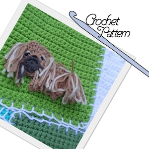 May include: A crocheted Pekingese dog with brown and white fur, sitting on a green crocheted background. The dog is surrounded by a white border and a blue and green border. The image also includes a crochet hook with the text "Crochet Pattern" above it.
