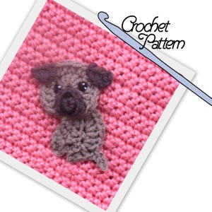 May include: A crochet pattern for a small brown pug dog. The pattern is shown on a pink crocheted square with a crochet hook in the background.