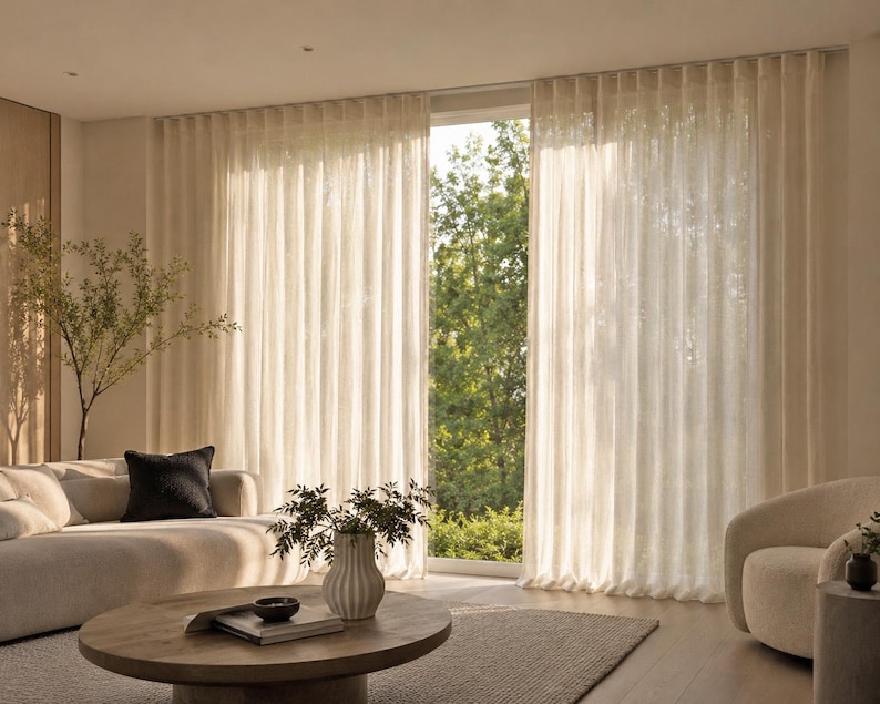 Modern living room with wall-to-wall sheer ripple fold curtains on a white ceiling mount aluminum track - soft daylight filtering through wave fold panels