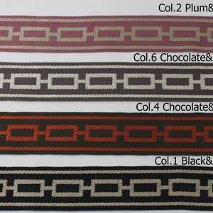 May include: Four samples of woven ribbon trim with geometric patterns. The colours are plum and beige, chocolate and silver, chocolate and brick, and black and beige.
