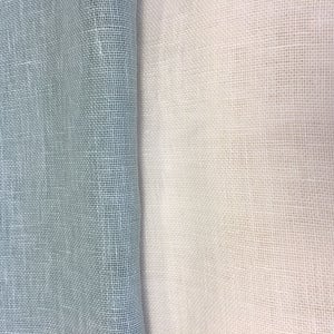 May include: Two pieces of fabric, one light blue and one white, both with a woven texture.