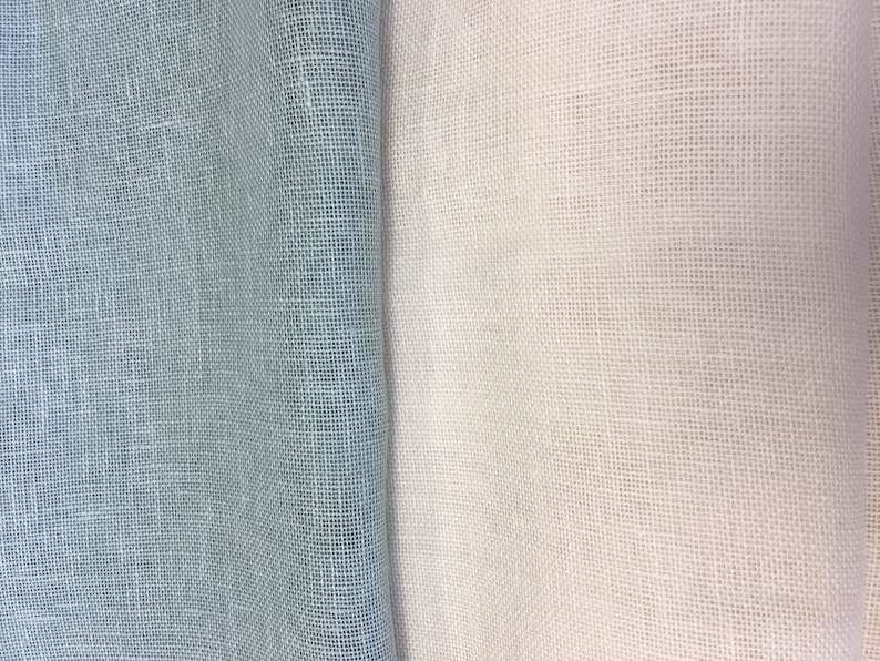 May include: Two pieces of fabric, one light blue and one white, both with a woven texture.