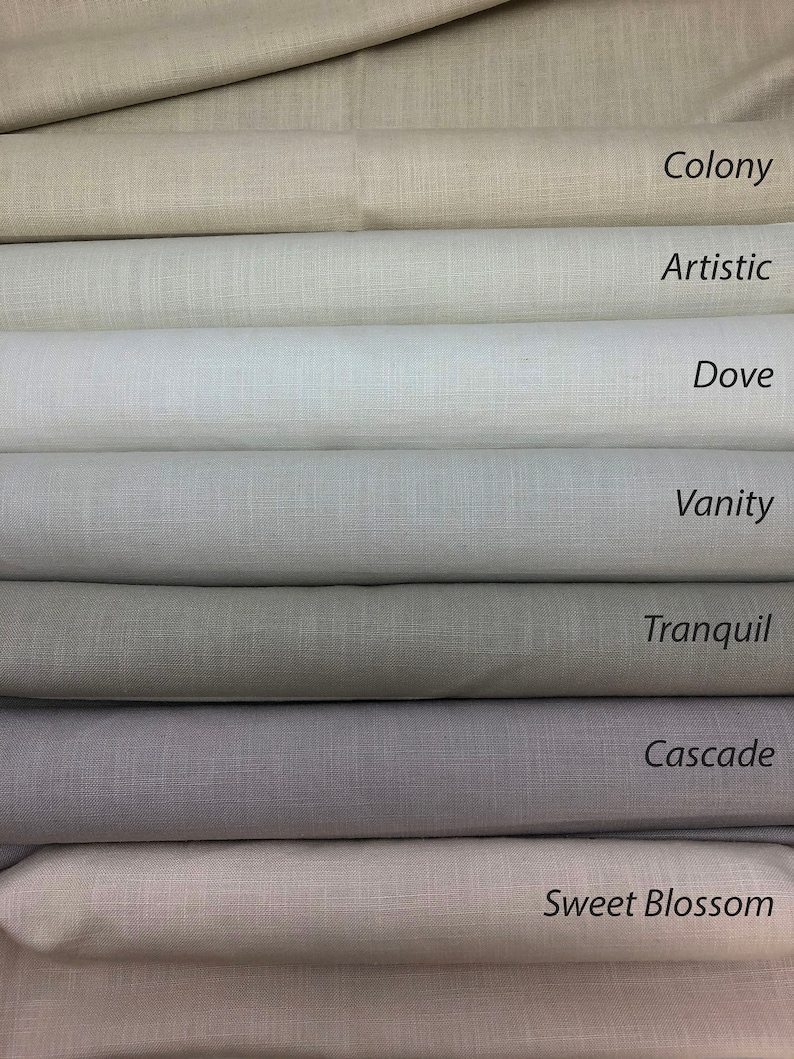 May include: Close-up of eight fabric swatches in various shades of beige, gray, and white. The swatches are labeled with the names "Colony", "Artistic", "Dove", "Vanity", "Tranquil", "Cascade", "Sweet Blossom".