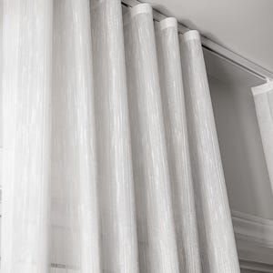 Sheer white striped curtains draping in gentle s-fold waves from a ceiling-mounted ripple fold track - flush ceiling installation for a floating curtain look