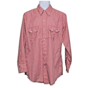 May include: A long-sleeve button-down shirt featuring a red and white gingham check pattern. The shirt includes a pointed collar, two chest pockets with flaps, and white buttons down the front placket and on the cuffs of the long sleeves.
