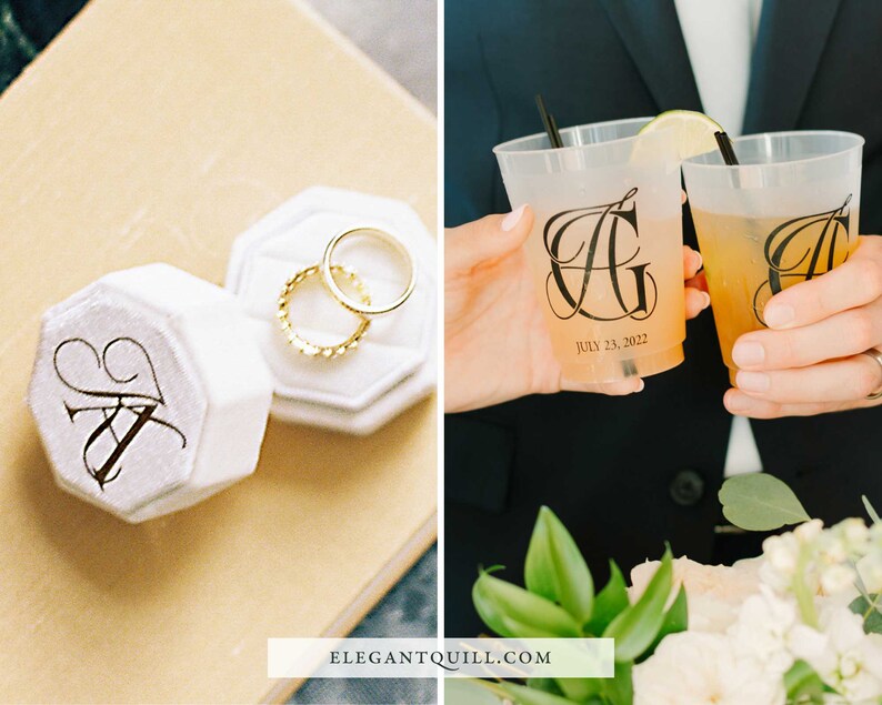 May include: Two white ring boxes with black calligraphy initials "AG" and the date "July 23, 2022". The boxes are open and contain two gold wedding bands. Two clear plastic cups with black calligraphy initials "AG" and the date "July 23, 2022" are filled with a light yellow beverage.